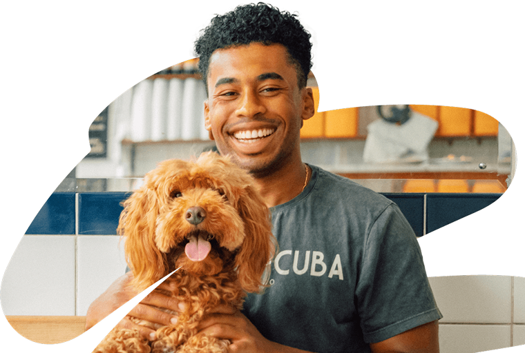 Man smiling with dog sticking out tongue